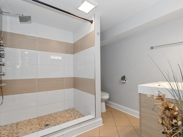 bathroom featuring tile patterned floors, toilet, and a stall shower