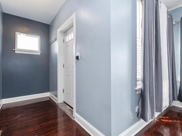 entryway with baseboards and wood-type flooring