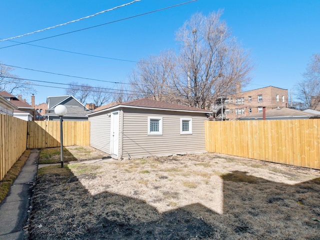 view of yard featuring an outbuilding and a fenced backyard