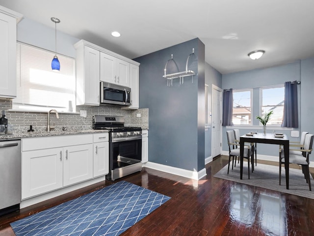 spare room featuring hardwood / wood-style floors, recessed lighting, and baseboards