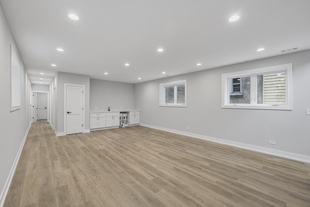 3308 S Leavitt St, Chicago, IL 60608 - below grade area with baseboards, visible vents, recessed lighting, and light wood-type flooring