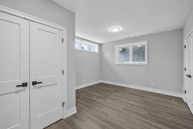 3308 S Leavitt St, Chicago, IL 60608 - unfurnished bedroom with baseboards, a closet, and dark wood-type flooring