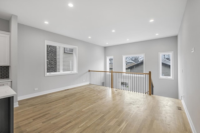 3308 S Leavitt St, Chicago, IL 60608 - unfurnished living room with baseboards, light wood-style floors, and recessed lighting