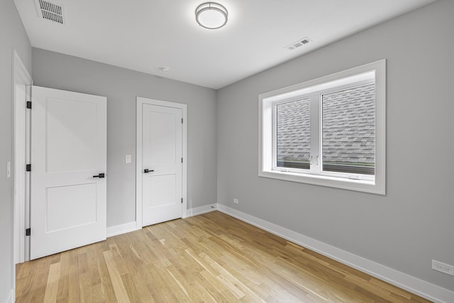 3308 S Leavitt St, Chicago, IL 60608 - unfurnished bedroom with baseboards, visible vents, and light wood-style floors
