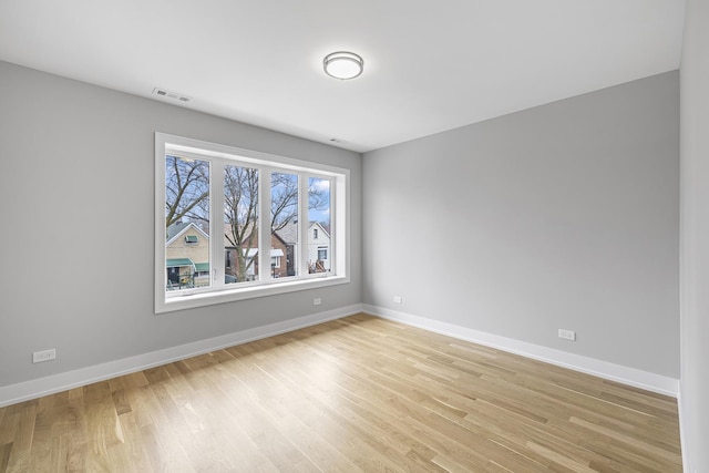 3308 S Leavitt St, Chicago, IL 60608 - spare room with light wood finished floors, baseboards, and visible vents