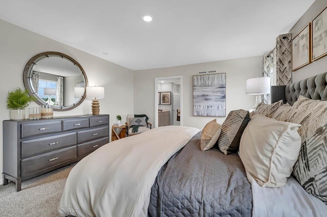 bedroom featuring recessed lighting, light colored carpet, and connected bathroom