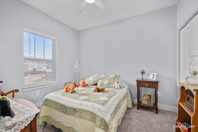 carpeted bedroom with a closet, ceiling fan, and baseboards