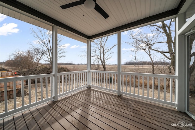 wooden terrace with a rural view and a ceiling fan