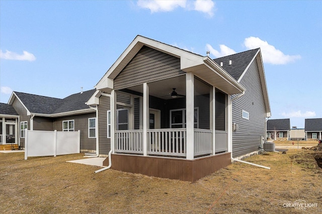 rear view of property featuring cooling unit and a sunroom