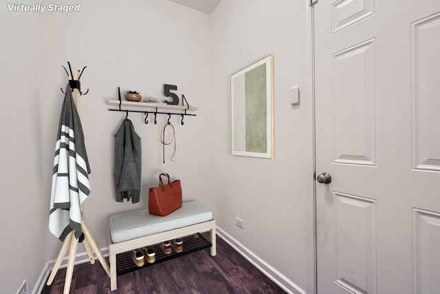 mudroom featuring baseboards and dark wood-type flooring