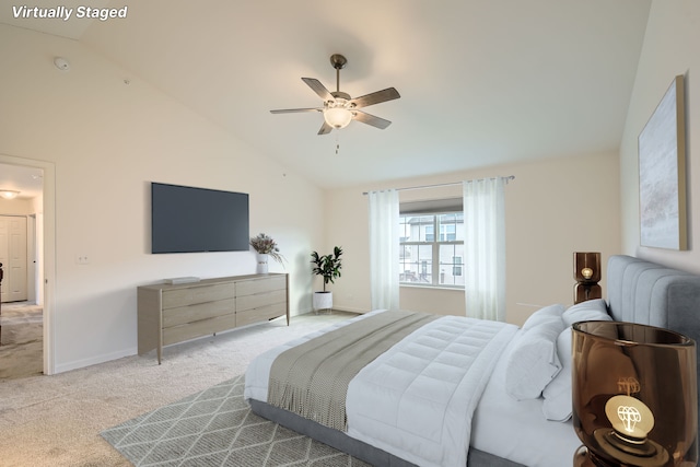 bedroom featuring baseboards, carpet floors, high vaulted ceiling, and a ceiling fan