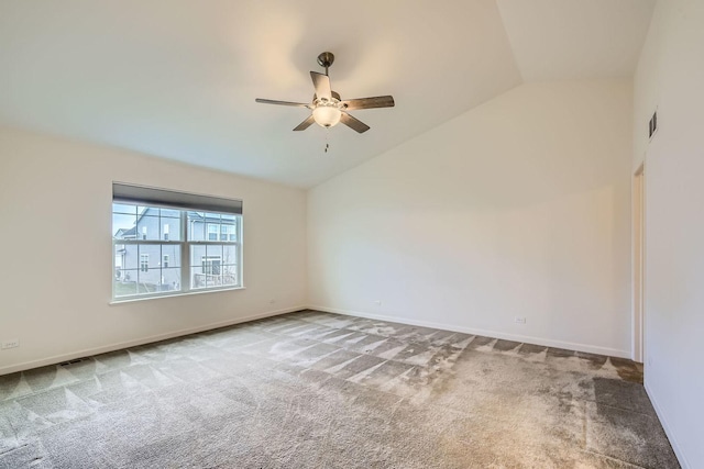 spare room featuring carpet flooring, visible vents, a ceiling fan, and lofted ceiling