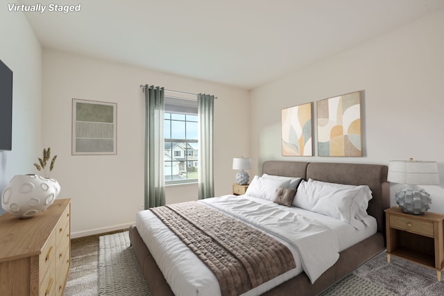 carpeted bedroom featuring baseboards