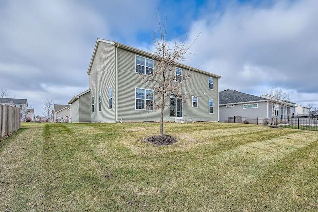 back of house with a yard and fence