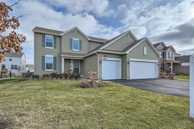 traditional home featuring aphalt driveway, fence, a garage, and a front lawn