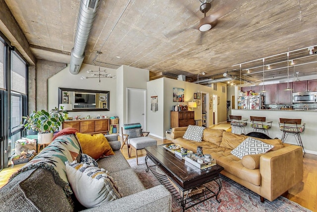 living room featuring baseboards and wood finished floors