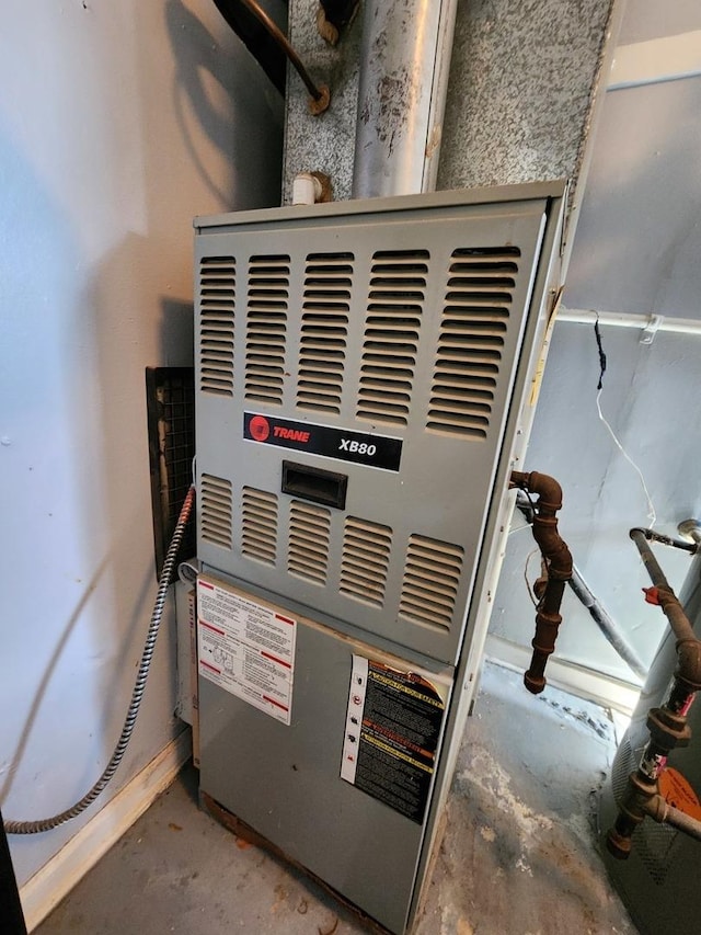 utility room featuring heating unit