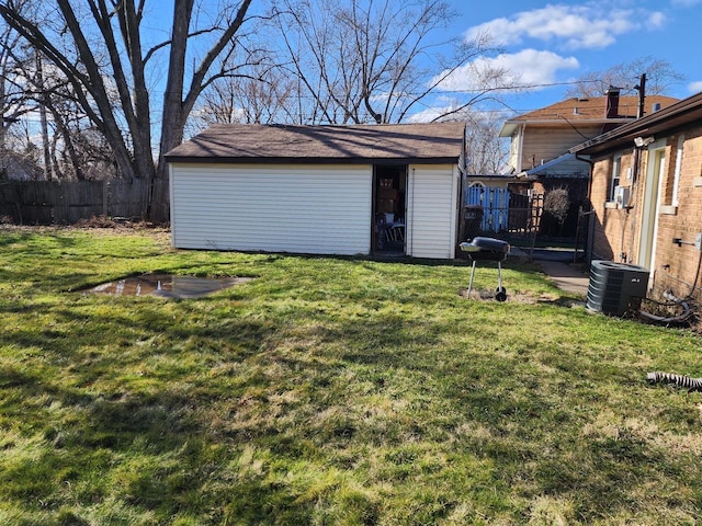 exterior space with central air condition unit, an outdoor structure, and fence