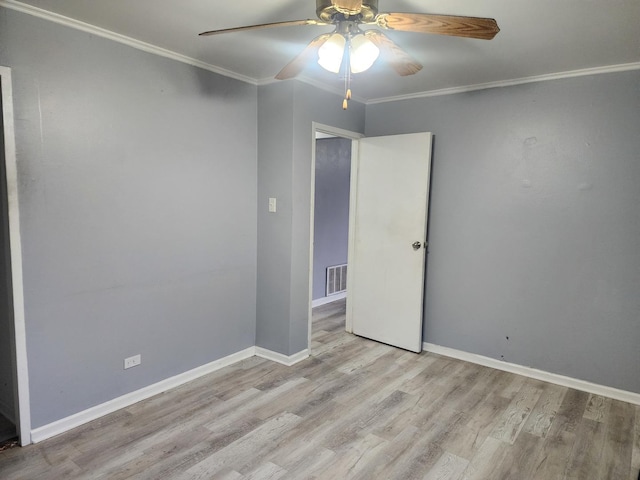 unfurnished room with ceiling fan, baseboards, wood finished floors, and ornamental molding