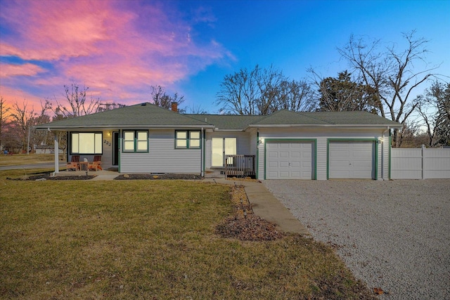 single story home with fence, a front yard, a chimney, driveway, and an attached garage