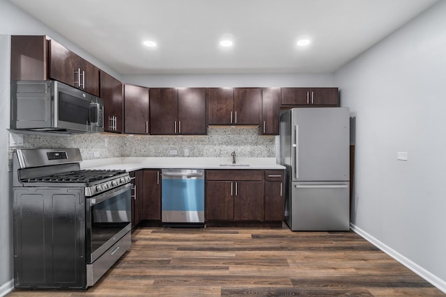 kitchen featuring dark wood-style floors, dark brown cabinets, appliances with stainless steel finishes, and light countertops