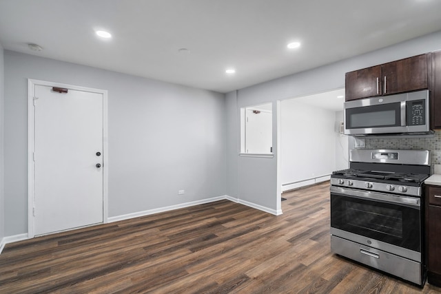 kitchen featuring backsplash, dark brown cabinets, dark wood-type flooring, stainless steel appliances, and a baseboard radiator