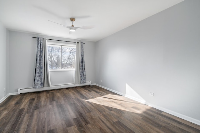 spare room featuring a baseboard heating unit, wood finished floors, baseboards, and ceiling fan