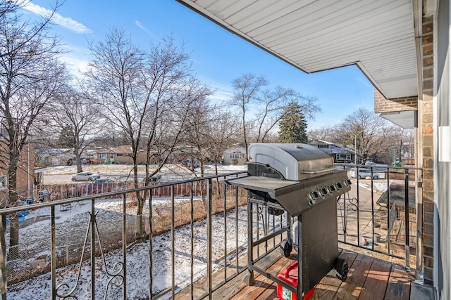 snow covered back of property featuring area for grilling