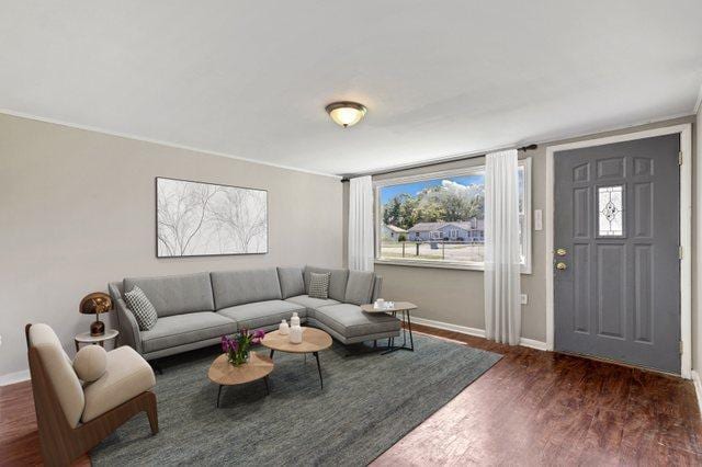 living room featuring baseboards and wood finished floors