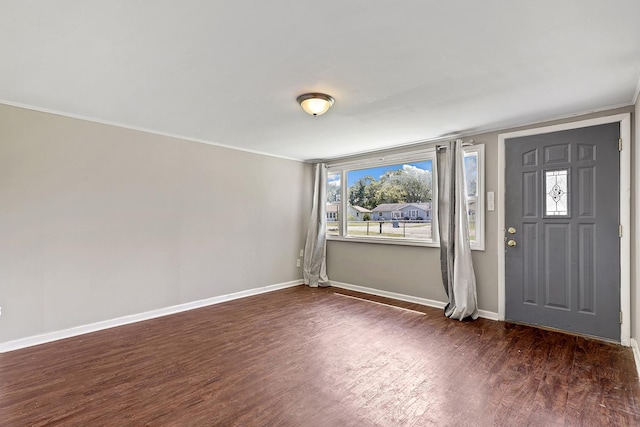 entrance foyer featuring wood finished floors, baseboards, and ornamental molding