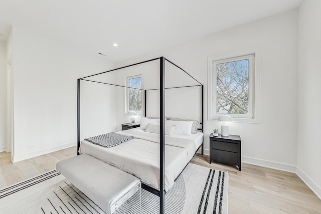 bedroom with recessed lighting, baseboards, and light wood finished floors