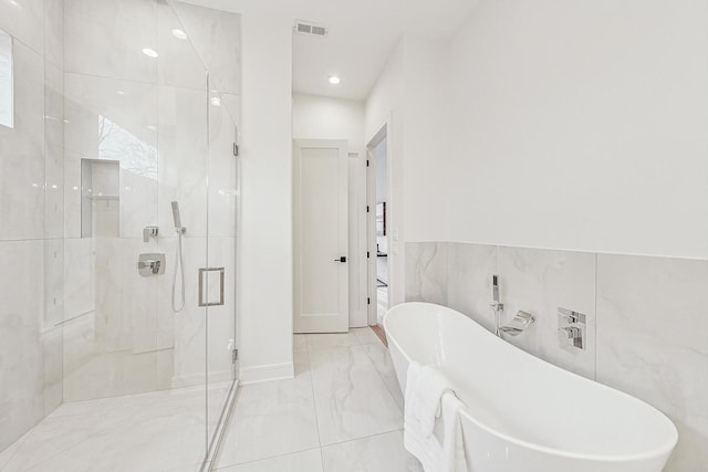 full bath with a shower stall, visible vents, marble finish floor, and a freestanding bath