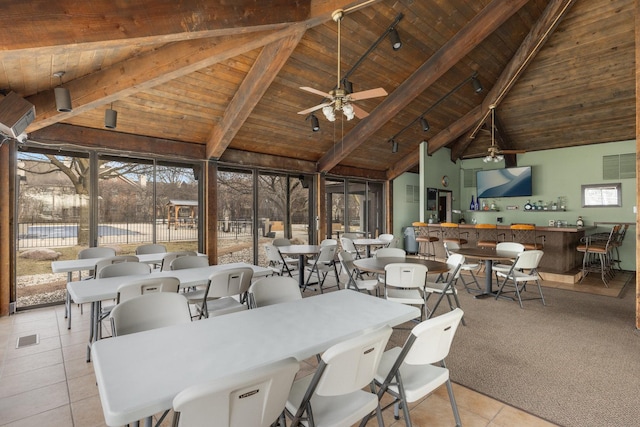 interior space featuring tile patterned floors, wood ceiling, ceiling fan, and beam ceiling