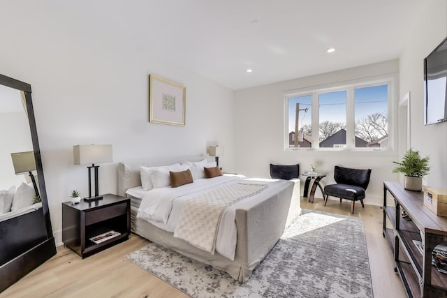 bedroom with recessed lighting and wood finished floors