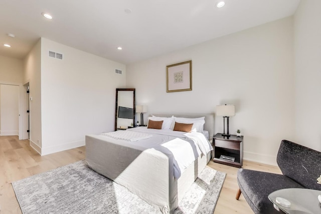 bedroom with recessed lighting, visible vents, baseboards, and light wood finished floors