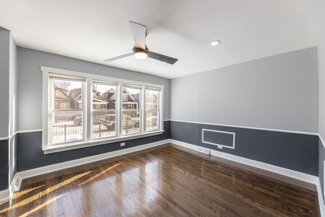 unfurnished room with a wealth of natural light, visible vents, baseboards, and wood finished floors