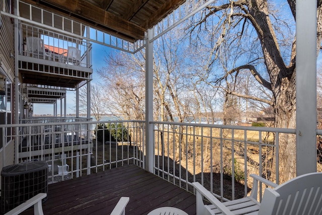 wooden deck featuring cooling unit