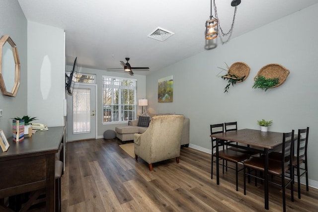 living area featuring ceiling fan, visible vents, baseboards, and wood finished floors