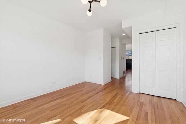 interior space with visible vents, light wood-style floors, and baseboards