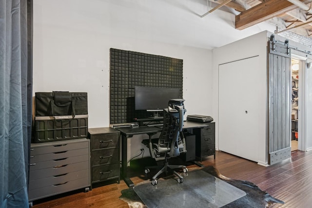 office space featuring dark wood finished floors and a barn door