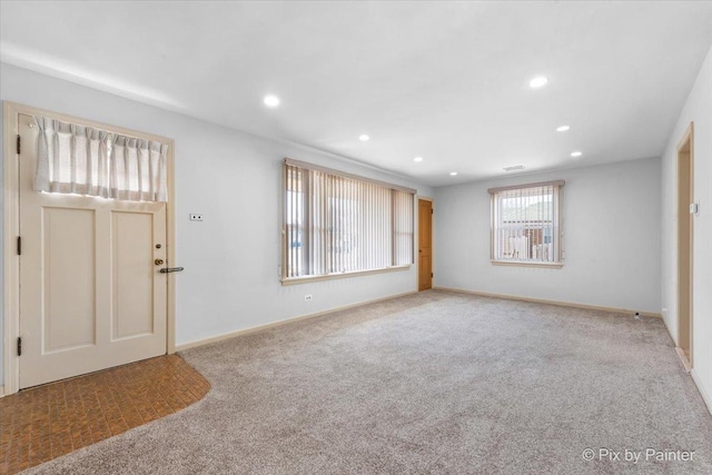 carpeted foyer with recessed lighting, visible vents, and baseboards