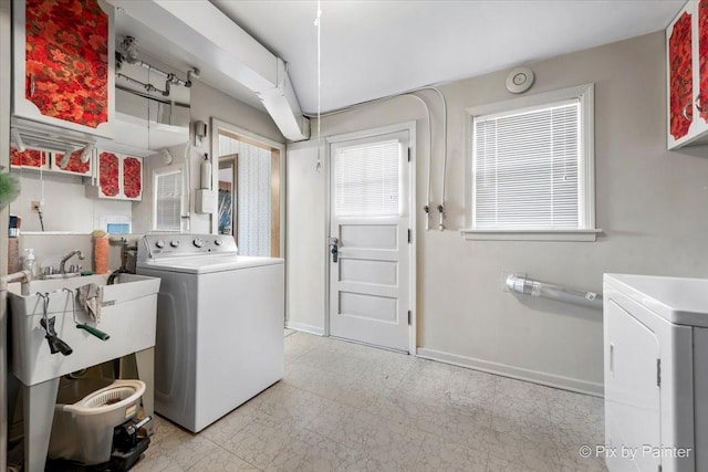 laundry area featuring a sink, baseboards, independent washer and dryer, and laundry area