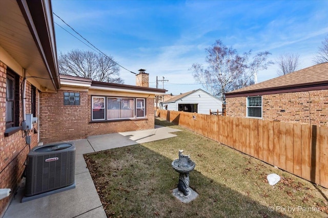 view of yard featuring a patio area, central air condition unit, and fence