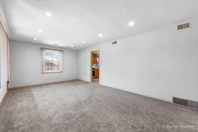 empty room featuring recessed lighting, visible vents, and light colored carpet