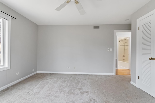 unfurnished bedroom with visible vents, baseboards, carpet flooring, a closet, and a ceiling fan