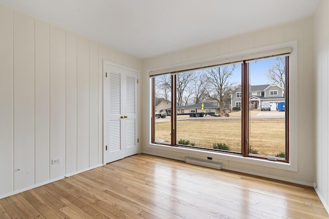 spare room featuring visible vents, baseboards, and light wood-style floors