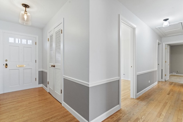 foyer featuring light wood finished floors and baseboards