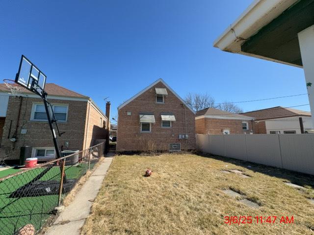 view of yard with central AC unit and fence