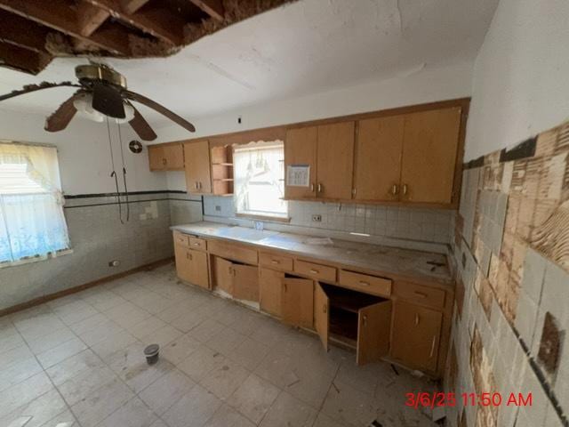 kitchen featuring a ceiling fan, open shelves, light floors, and light countertops