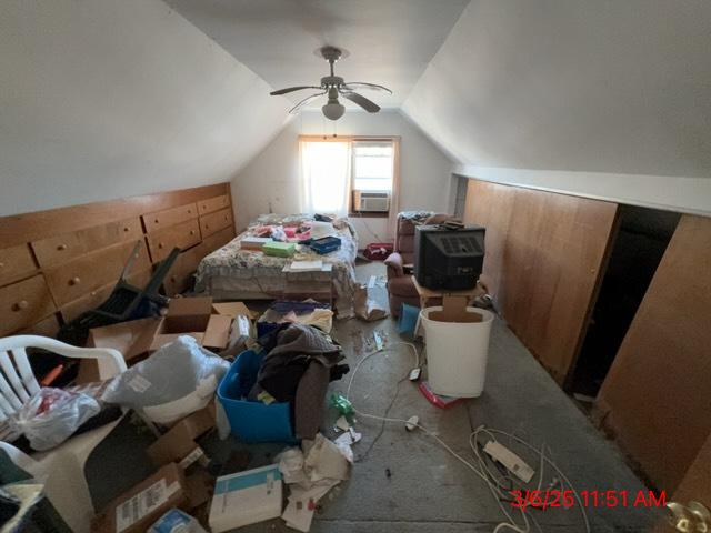 bedroom with lofted ceiling, cooling unit, and a ceiling fan